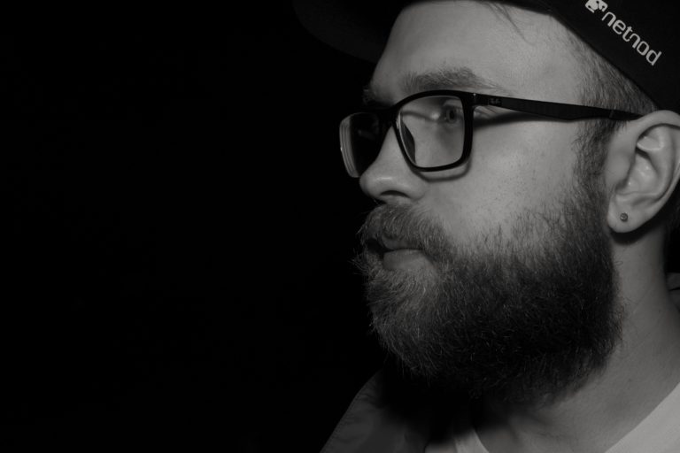 Young man with glasses and beard, black and white