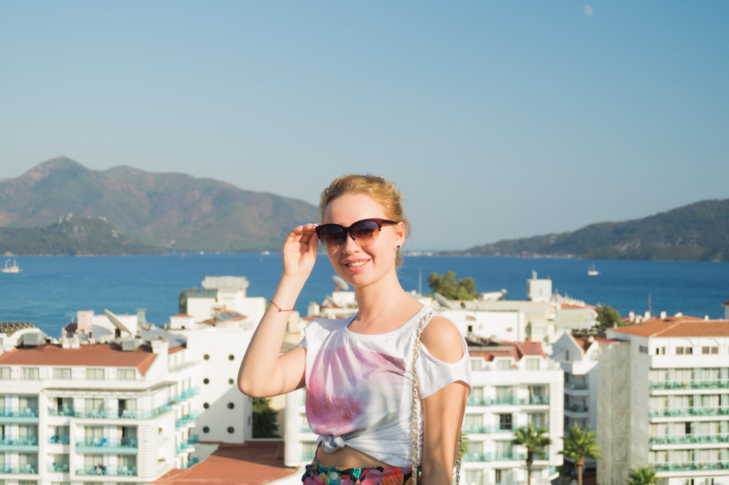 Young woman with sunglasses smiling