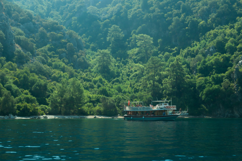 Recreation on the boat near the shore of a mountain