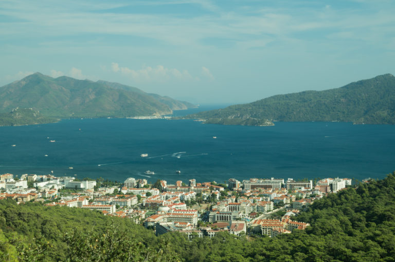 Nature landscape with a city by the shore of the sea between the hills. mountain town panoramic view