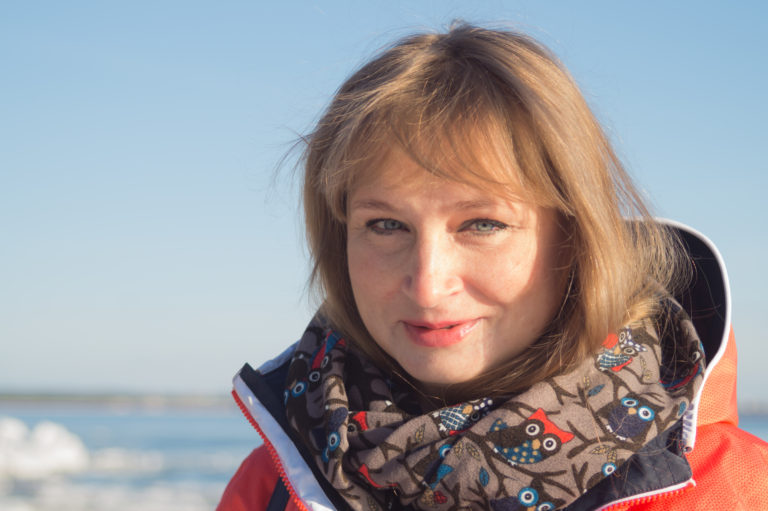 Woman standing by the sea, smiling woman, smile