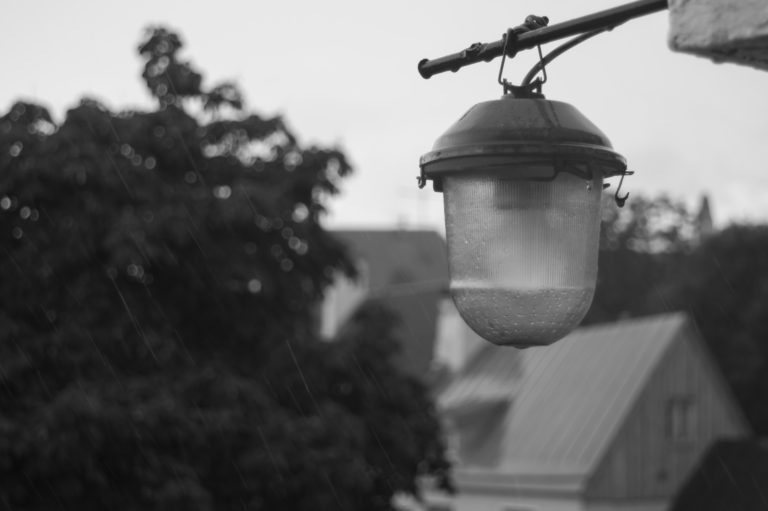 The old lantern hanging on the wall of the house background