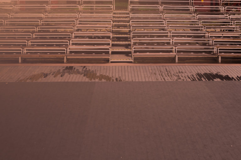 Empty benches on tribune with scene background