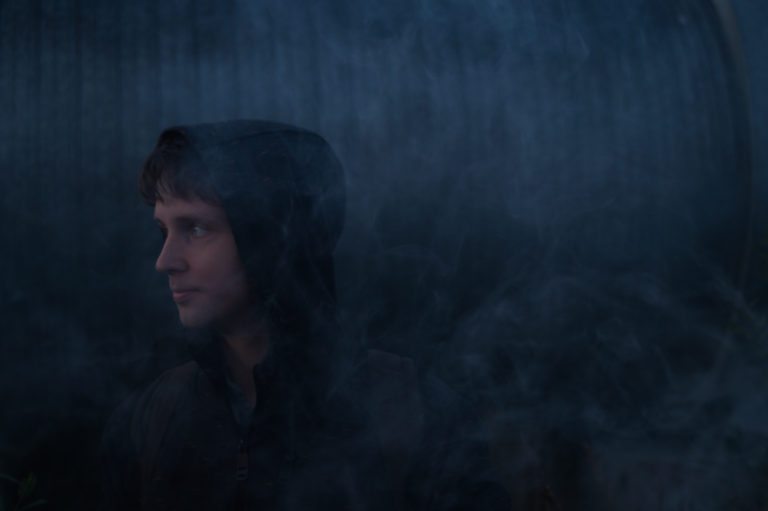 Man in smoke on the dark background